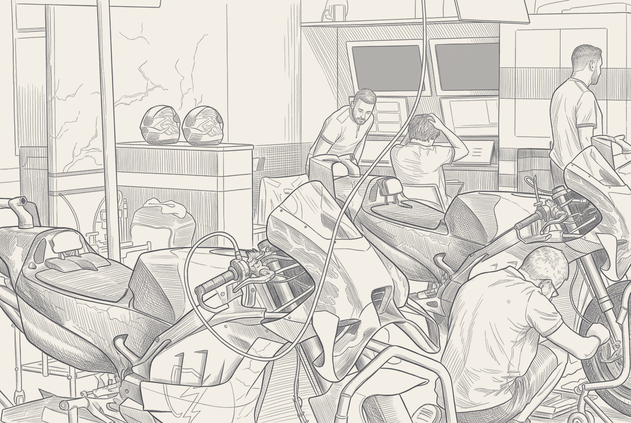 A MotoGP garage drawn in cross-section, one bike under work lights at the front, a second bike shrouded and sealed inside a transporter behind a chain, a contract document pinned to the wall between them.